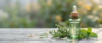 Essential oil bottle with dropper and fresh herbs on wooden surface for natural wellness aromatherapy spa treatments and holistic health remedies.