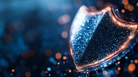 Glowing shield shape with sparkling blue particles and orange bokeh lights on dark background, symbolizing digital security and cyber protection.