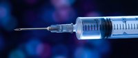 Medical syringe with needle on dark blue background with bokeh lights for healthcare and vaccination concepts.