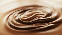 Smooth chocolate swirl texture with rich brown tones, ideal for backgrounds, confectionery packaging, and dessert-related design projects.
