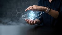 Hands of a young woman holding a glowing digital fingerprint hologram, symbolizing biometric security, identity verification, and cyber protection.