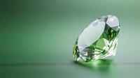 Sparkling green diamond gemstone on blurred emerald background with soft reflection and facets catching light, suitable for jewelry advertising and luxury concepts.