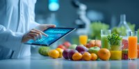Nutritionist analyzing health data on tablet with fresh fruits, vegetables, and juices in modern laboratory setting.