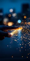 Magical glowing sparkles emanate from fingertips against dark blue night sky with bokeh lights, creating ethereal atmosphere for fantasy and creative concepts.