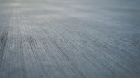 Weathered gray wood surface with natural grain texture and shallow depth of field creating soft blur effect for backgrounds and design projects.