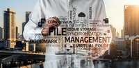 Professional businessman presenting digital file management and cloud storage solutions with technology keywords overlay against modern city skyline.