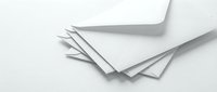 Stack of white paper envelopes on a light background, symbolizing mail, correspondence, and communication in business or personal use.