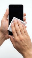 Caucasian male hands cleaning smartphone screen with microfiber cloth against white background. Isolated stock photo suitable for technology, electronics care, and device maintenance concepts.
