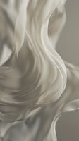 Flowing white silk fabric with smooth, undulating waves and soft folds creating an elegant, abstract composition against neutral background for luxury design projects.