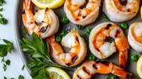 Grilled jumbo shrimp with fresh lemon slices, parsley garnish and herbs on white plate. Succulent seafood appetizer prepared with citrus and aromatics.