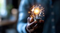 Glowing light bulb with digital network connections floating above hand, symbolizing innovation, creative ideas and technological advancement in business solutions.
