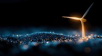 Wind turbine illuminated at night against bokeh city lights background, glowing in warm and cool tones creating atmospheric renewable energy scene.