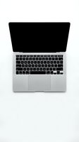 Silver laptop with black keyboard and screen displayed open from above on white background, isolated for web design, marketing, technology presentations, and business graphics.
