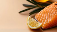 Fresh salmon fillet with lemon slice and rosemary garnish on neutral background, suitable for food photography, culinary blogs, restaurant menus, and healthy eating content.