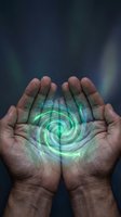 Cupped hands holding glowing green energy spiral with mystical aurora background for healing and spiritual wellness concepts.