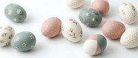 Easter eggs collection in pastel green pink and cream colors with floral patterns and polka dots isolated on white background for spring holiday decoration.