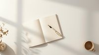 Minimalist workspace with open notebook, wooden pen, and coffee cup on white desk with soft natural lighting and plant shadows for productivity and planning.