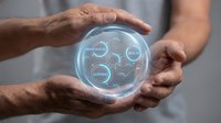 Hands holding glowing sphere with digital interface displaying data analytics, innovation, and technology concepts for business solutions and future growth.
