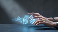 Female hands creating magical blue glowing swirls and energy waves with flowing mystical light effects on dark surface for digital art and fantasy concepts.