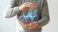 Businessman protecting glowing sustainability hologram with upward trending graph showing environmental growth and eco-friendly business development concept.