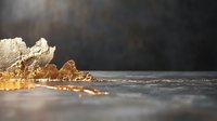 Luxurious gold leaf fragments scattered on dark textured surface with dramatic lighting and shallow depth of field creating artistic composition.