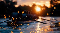 Dramatic macro shot of water droplets with golden bokeh lights at sunset creating magical atmosphere. Reflective surface catches warm sunlight in nature.