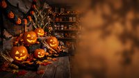 Halloween pumpkins jack-o-lanterns glowing on rustic wooden table with autumn leaves and warm bokeh lights creating festive spooky atmosphere.