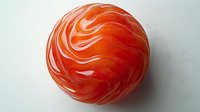 Vibrant red and white swirled glass marble sphere on light background with soft shadow, showcasing elegant marbled pattern and glossy reflective surface.