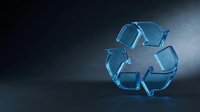 Blue glass recycling symbol on dark background with dramatic lighting for environmental sustainability and waste management concepts.