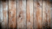 Rustic wooden planks background with natural grain texture and vignette effect. Weathered brown boards create vintage farmhouse atmosphere for design projects.