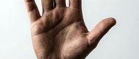 Close-up of an open male hand with medium skin tone against a neutral background, suitable for healthcare, communication, and gesture-based design projects.