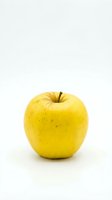 Fresh yellow apple isolated on white background for healthy eating and nutrition concepts.
