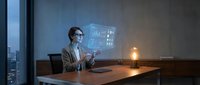 Professional businessman analyzing financial data with holographic display in modern office during evening hours for business intelligence and analytics.