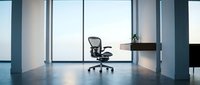 Modern minimalist office interior with ergonomic chair and wooden desk near large windows. Clean corporate workspace design for business productivity.