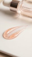 Shimmering liquid foundation or highlighter with dropper applicator on neutral background for cosmetics and beauty product marketing.