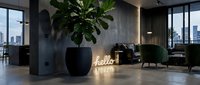 Modern dark interior lounge with neon hello sign, large fiddle leaf fig plant, green velvet chairs, and city view through floor-to-ceiling windows.