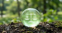 Environmental law concept with scales of justice in glass sphere on soil representing legal balance between nature and industry for sustainability.