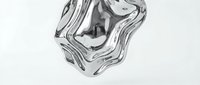Liquid metal swirl with reflective surface creating abstract flowing waves and organic shapes on white background.