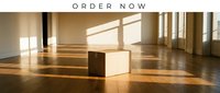 Cardboard box on wooden floor in sunlit empty room with large windows, warm light and shadows creating a minimalist moving concept.
