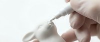 Medical professional administering injection with syringe in clinical setting. Healthcare worker wearing protective gloves performing vaccination procedure.