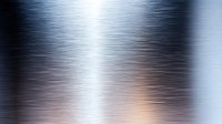 Brushed metal surface with silver and copper tones creating dynamic light reflections and horizontal streaks, metallic texture background for industrial designs.