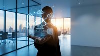 Businessman holding glowing cloud services hologram in modern office, showcasing digital network, data storage, and technology innovation concept.