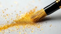 Makeup brush sweeping through scattered gold glitter powder on white surface, creating dynamic motion trail and sparkle effect for cosmetic and beauty concepts.