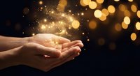 Cupped hands releasing magical golden light particles and sparkles against dark background with warm bokeh lights for spiritual and mystical concepts.