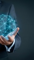 Businessman holding glowing digital network sphere with connected lines representing global connectivity, technology innovation and data management solutions.