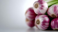 Fresh garlic bulbs with purple and white striped skin clustered together, showing natural texture and detail for culinary, food styling, and ingredient photography.