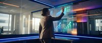Professional businesswoman analyzing holographic financial data charts and graphs in modern office environment with futuristic technology interface display.