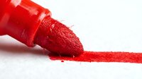 Red marker tip with vibrant pigment stroke on white background, isolated for design, crafts, art projects, education, and creative applications.