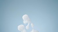Young child with light skin tone, approximately 2-3 years old, wearing white clothing, photographed against clear blue sky. Suitable for parenting, childcare, family lifestyle, and developmental content.