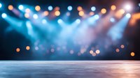 Stage with dramatic blue spotlights and orange bokeh effects creating atmospheric concert or theater background, empty performance space with smoky ambiance.
